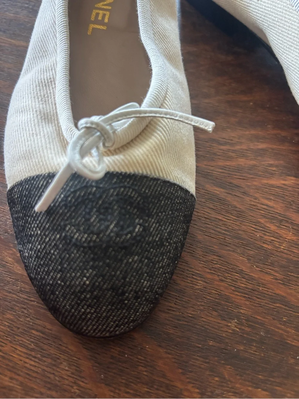 CHANEL Ivory Canvas Ballet Flats with Black Cap Toe and Bow